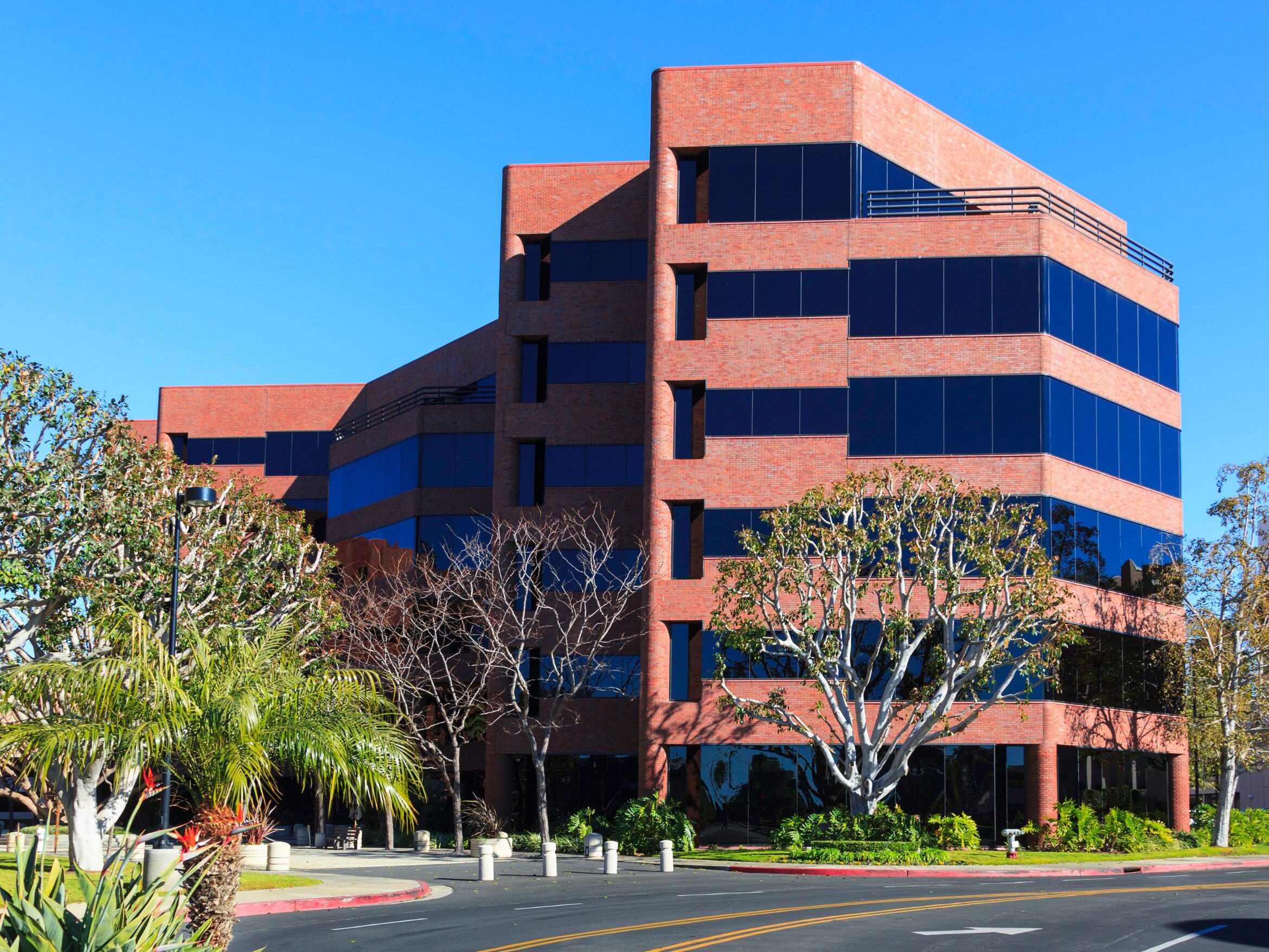 A stylish red office building made of brick.